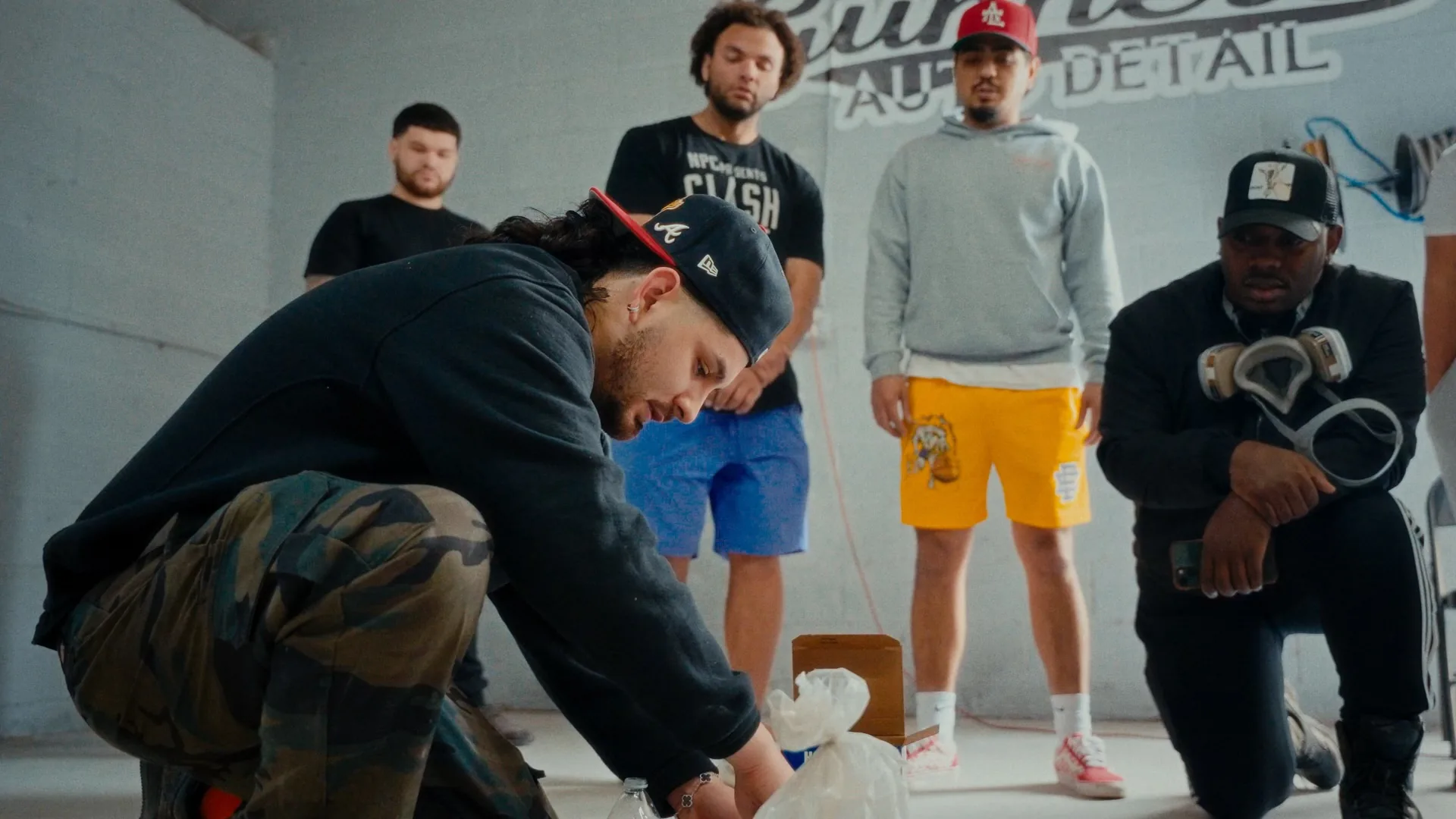 JP demonstrating prep work while the crew watches