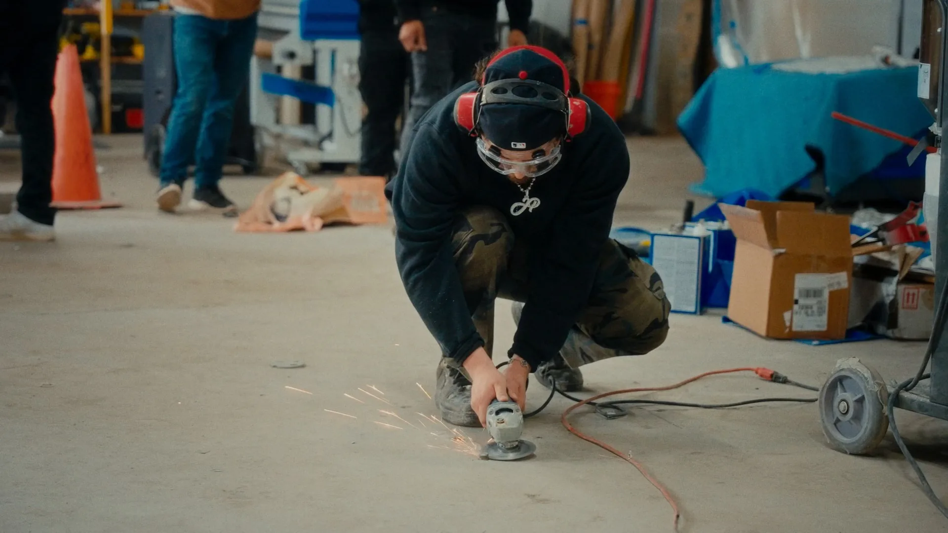 Grinding the slab before a pour, sparks under the wheel